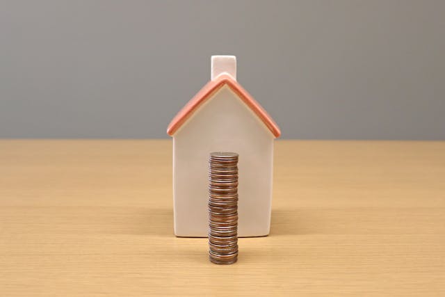 a%20home%20figurine%20with%20a%20stack%20of%20coins%20in%20front%20of%20it
